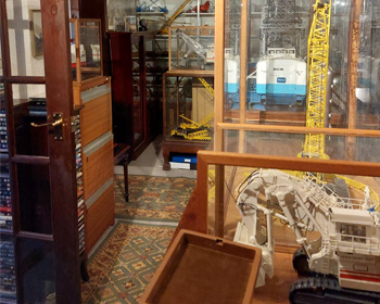 Collection of display cabinets containing models of a digger and other machinery